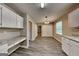 Kitchen with hardwood floors, white cabinets, granite countertops and a built-in desk at 1311 Bustling Sw Ln, Marietta, GA 30064