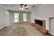Bright living room with neutral paint, carpet, ceiling fan and a brick fireplace at 1311 Bustling Sw Ln, Marietta, GA 30064