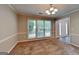 Traditional living room with carpet, natural light from a multi-pane window and paneled walls at 1311 Bustling Sw Ln, Marietta, GA 30064