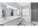 Bright bathroom featuring double sinks, a large mirror, and a separate tub and shower at 115 Roscommon Ct, Tyrone, GA 30290