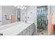 Bathroom with white vanity, decorative mirror, and combination shower and tub at 115 Roscommon Ct, Tyrone, GA 30290