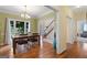 Elegant dining area featuring hardwood floors, large windows, and a seamless transition to other living spaces at 115 Roscommon Ct, Tyrone, GA 30290