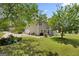 View of the home's rear exterior showcases a spacious yard, patio area, and access to the garage, perfect for outdoor living at 115 Roscommon Ct, Tyrone, GA 30290
