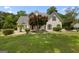 Charming home featuring stone accents, a well-manicured lawn, and a vibrant red front door at 115 Roscommon Ct, Tyrone, GA 30290