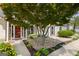 Inviting front entrance featuring a red door, decorative stones, and manicured landscaping at 115 Roscommon Ct, Tyrone, GA 30290