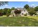 Charming home featuring a manicured lawn, mature trees, and a welcoming facade at 115 Roscommon Ct, Tyrone, GA 30290
