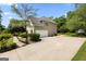 Spacious garage and driveway offering ample parking, set amidst a landscaped yard at 115 Roscommon Ct, Tyrone, GA 30290
