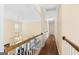 Upstairs hallway with wood floors and white trim provides an open, airy feel at 115 Roscommon Ct, Tyrone, GA 30290