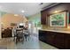 Kitchen with stainless dishwasher, tile floors, eat-in table, and plenty of natural light at 115 Roscommon Ct, Tyrone, GA 30290