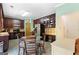 Eat-in kitchen with dark cabinets, stainless steel appliances, and a glass-top dining table at 115 Roscommon Ct, Tyrone, GA 30290