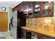 Kitchen with stainless steel refrigerator, granite counters, and glass front cabinets at 115 Roscommon Ct, Tyrone, GA 30290