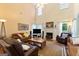Bright and airy living room with high ceilings, fireplace, and comfortable seating arrangement at 115 Roscommon Ct, Tyrone, GA 30290