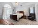 Main bedroom with ceiling fan, natural light, wooden bedframe, and carpeting at 115 Roscommon Ct, Tyrone, GA 30290