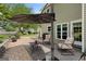 Cozy patio with comfortable seating, perfect for relaxing outdoors with a patio umbrella for shade at 115 Roscommon Ct, Tyrone, GA 30290