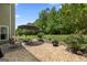 A view of the stone patio with a seating area and a fire pit, ideal for relaxing in the landscaped backyard at 115 Roscommon Ct, Tyrone, GA 30290