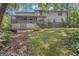 A large back exterior showcases a lush yard and a partially covered deck area at 886 Pine Needle Rd, Hampton, GA 30228