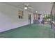 Spacious back porch with ceiling fan and white siding offers a relaxing outdoor space at 886 Pine Needle Rd, Hampton, GA 30228