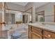 Bathroom featuring a soaking tub, vanity sink, and a large mirror at 886 Pine Needle Rd, Hampton, GA 30228