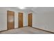 Bedroom featuring neutral walls, carpet flooring, and 3 doors at 886 Pine Needle Rd, Hampton, GA 30228