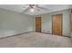 A bright, carpeted bedroom boasts natural light and two closet doors at 886 Pine Needle Rd, Hampton, GA 30228