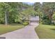 Traditional brick home boasts a two-car garage and well-maintained lawn at 886 Pine Needle Rd, Hampton, GA 30228