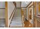 Inviting foyer features hardwood floors and a carpeted staircase leading to the second floor at 886 Pine Needle Rd, Hampton, GA 30228