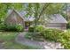 Inviting brick home features a lush lawn and an attached two-car garage at 886 Pine Needle Rd, Hampton, GA 30228