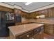 Kitchen with wood cabinets, laminate countertop and center island at 886 Pine Needle Rd, Hampton, GA 30228