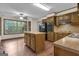 Eat-in kitchen with wood cabinets, island and black appliances at 886 Pine Needle Rd, Hampton, GA 30228