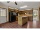 Eat-in kitchen featuring dark wood cabinets and island at 886 Pine Needle Rd, Hampton, GA 30228