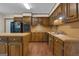 Spacious kitchen featuring wood cabinets, island, and black appliances at 886 Pine Needle Rd, Hampton, GA 30228