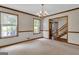 Bright living room with two windows, neutral carpet and traditional chandelier at 886 Pine Needle Rd, Hampton, GA 30228