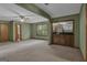 Large entertainment room with a retro wet bar and a view to the outdoors through a large window at 886 Pine Needle Rd, Hampton, GA 30228
