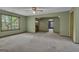 Spacious living room featuring a large window, wet bar, and neutral paint at 886 Pine Needle Rd, Hampton, GA 30228