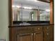 Close up view of a retro wet bar, featuring a sink, dark counter, and mirrored background at 886 Pine Needle Rd, Hampton, GA 30228
