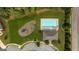 Overhead view of a community pool, playground, and clubhouse surrounded by lush greenery at 162 Aylesbury Blvd, Mcdonough, GA 30252