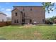 Large brick house backyard with a green lawn, patio, and outdoor grill at 162 Aylesbury Blvd, Mcdonough, GA 30252
