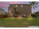 Large brick house backyard with a green lawn, patio, and outdoor grill at 162 Aylesbury Blvd, Mcdonough, GA 30252