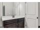 Bathroom vanity with dark cabinets, white countertop, and large mirror at 162 Aylesbury Blvd, Mcdonough, GA 30252