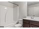 Bright bathroom showcasing a white shower/tub, toilet, and vanity with dark wood cabinet at 162 Aylesbury Blvd, Mcdonough, GA 30252