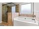 Bathroom showcasing a soaking tub and frameless walk-in shower with neutral tile at 162 Aylesbury Blvd, Mcdonough, GA 30252
