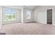 Bright bedroom with carpet, large window, and natural light at 162 Aylesbury Blvd, Mcdonough, GA 30252