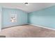 Bedroom with blue walls, carpet flooring, and window at 162 Aylesbury Blvd, Mcdonough, GA 30252
