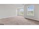 Open bedroom with natural light, large window, and carpet flooring at 162 Aylesbury Blvd, Mcdonough, GA 30252
