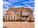 Two-story brick home with a well-manicured lawn and inviting front porch at 162 Aylesbury Blvd, Mcdonough, GA 30252