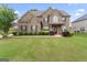 A beautiful brick home with lush landscaping and a well-manicured front lawn at 162 Aylesbury Blvd, Mcdonough, GA 30252