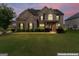 Charming brick home featuring manicured lawn, and inviting entrance; enhanced for appeal at 162 Aylesbury Blvd, Mcdonough, GA 30252