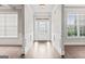 Bright foyer with hardwood floors, white trim, and ample natural light from the glass front door at 162 Aylesbury Blvd, Mcdonough, GA 30252