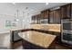 Modern kitchen featuring stainless steel appliances, granite countertops, dark cabinets, and a kitchen island at 162 Aylesbury Blvd, Mcdonough, GA 30252