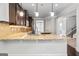 Spacious kitchen with granite counters, pendant lighting, stainless appliances, and center island with sink at 162 Aylesbury Blvd, Mcdonough, GA 30252